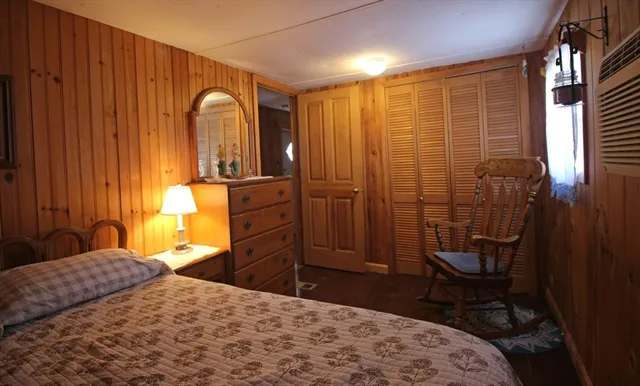 a bedroom with a bed and a dresser