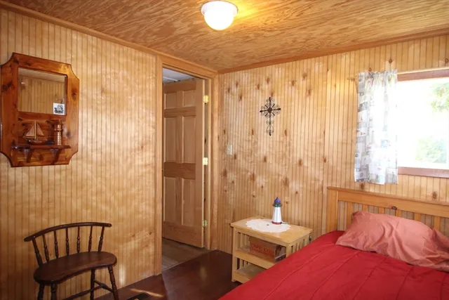 a bedroom with a bed and a chair