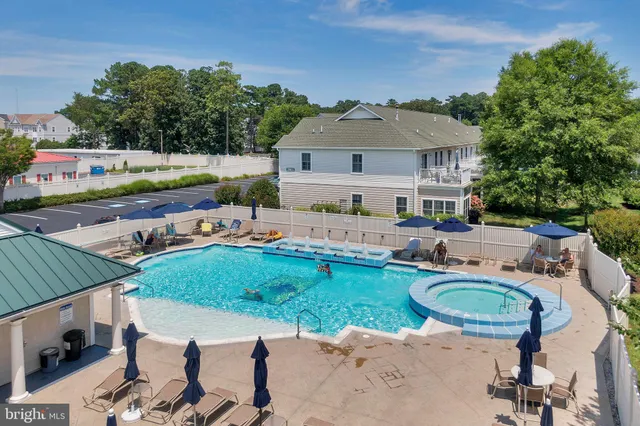 an aerial view of a house with swimming pool garden and patio
