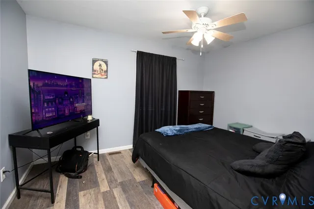 a view of a house with backyard and wooden fence