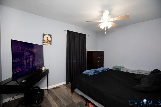 a balcony view with two plants and wooden fence