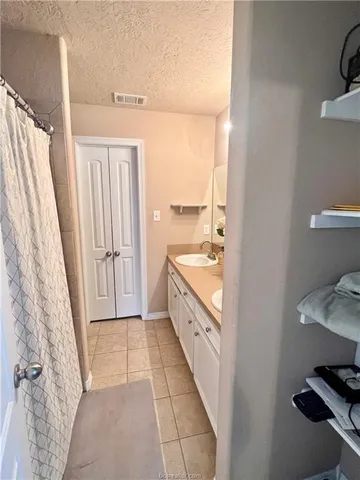 a bathroom with a double vanity sink and a bathtub