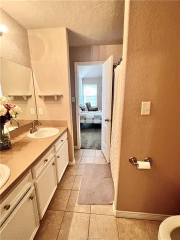 a bathroom with a sink a mirror and a toilet