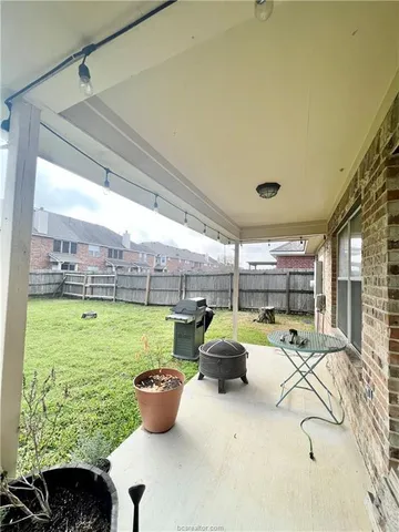 a room with furniture and a view of kitchen