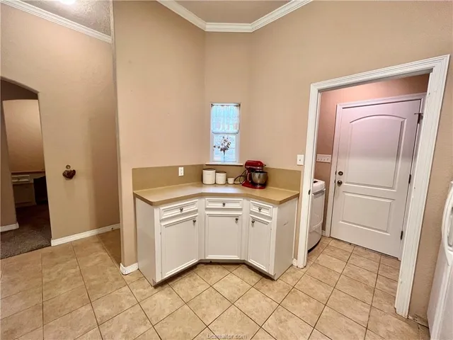 a utility room with cabinets washer and dryer