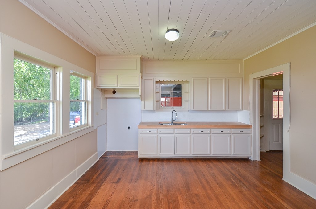 404 West Main Street Bellville, TX 77418 - Photo 12 of 25 a kitchen with granite countertop a stove and wooden floors