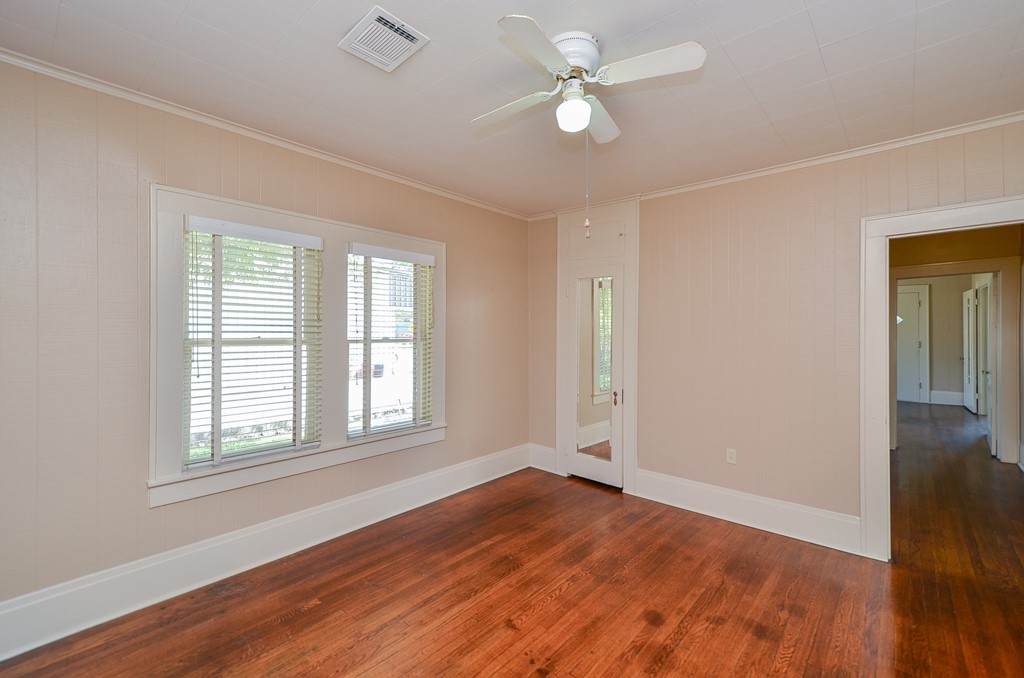 404 West Main Street Bellville, TX 77418 - Photo 15 of 25 an empty room with wooden floor fan and windows