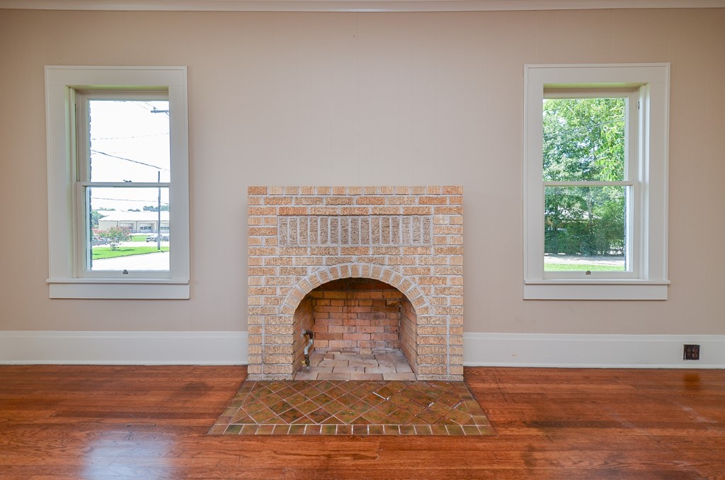 404 West Main Street Bellville, TX 77418 - Photo 6 of 25 a view of empty room with wooden floor and fireplace