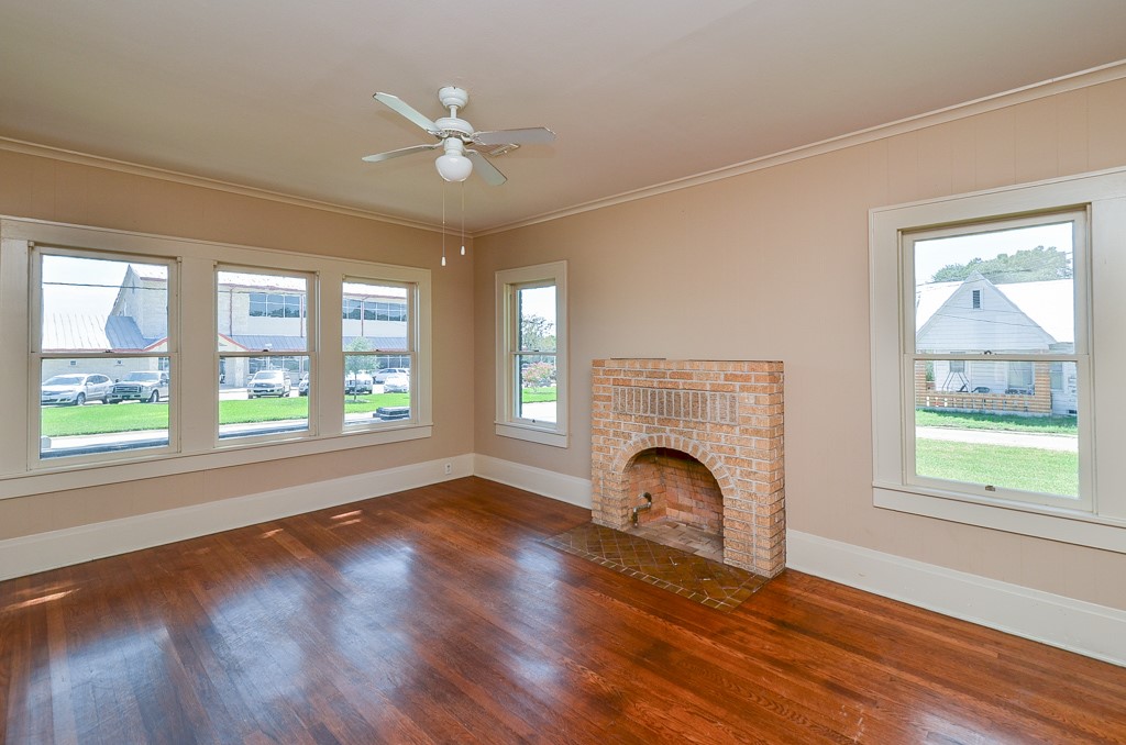 404 West Main Street Bellville, TX 77418 - Photo 7 of 25 a view of empty room with fireplace and wooden floor