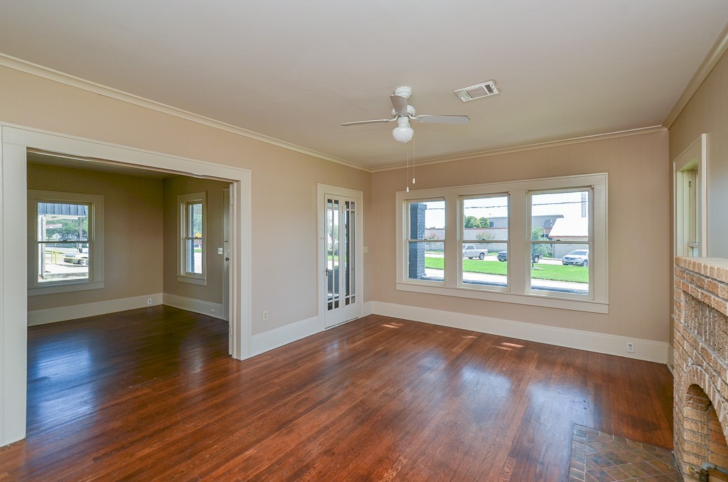 404 West Main Street Bellville, TX 77418 - Photo 8 of 25 a view of an empty room with wooden floor and a window
