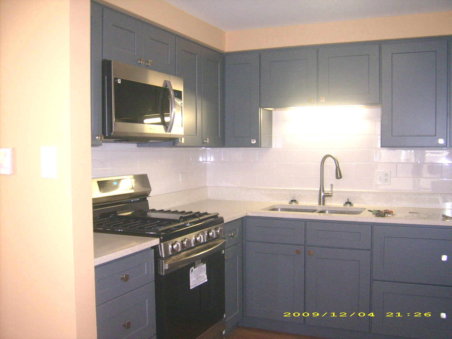 7019 West Irving Park Road, Unit 2 Chicago, IL 60634 - Photo 6 of 14 a kitchen with stainless steel appliances granite countertop a sink and a stove