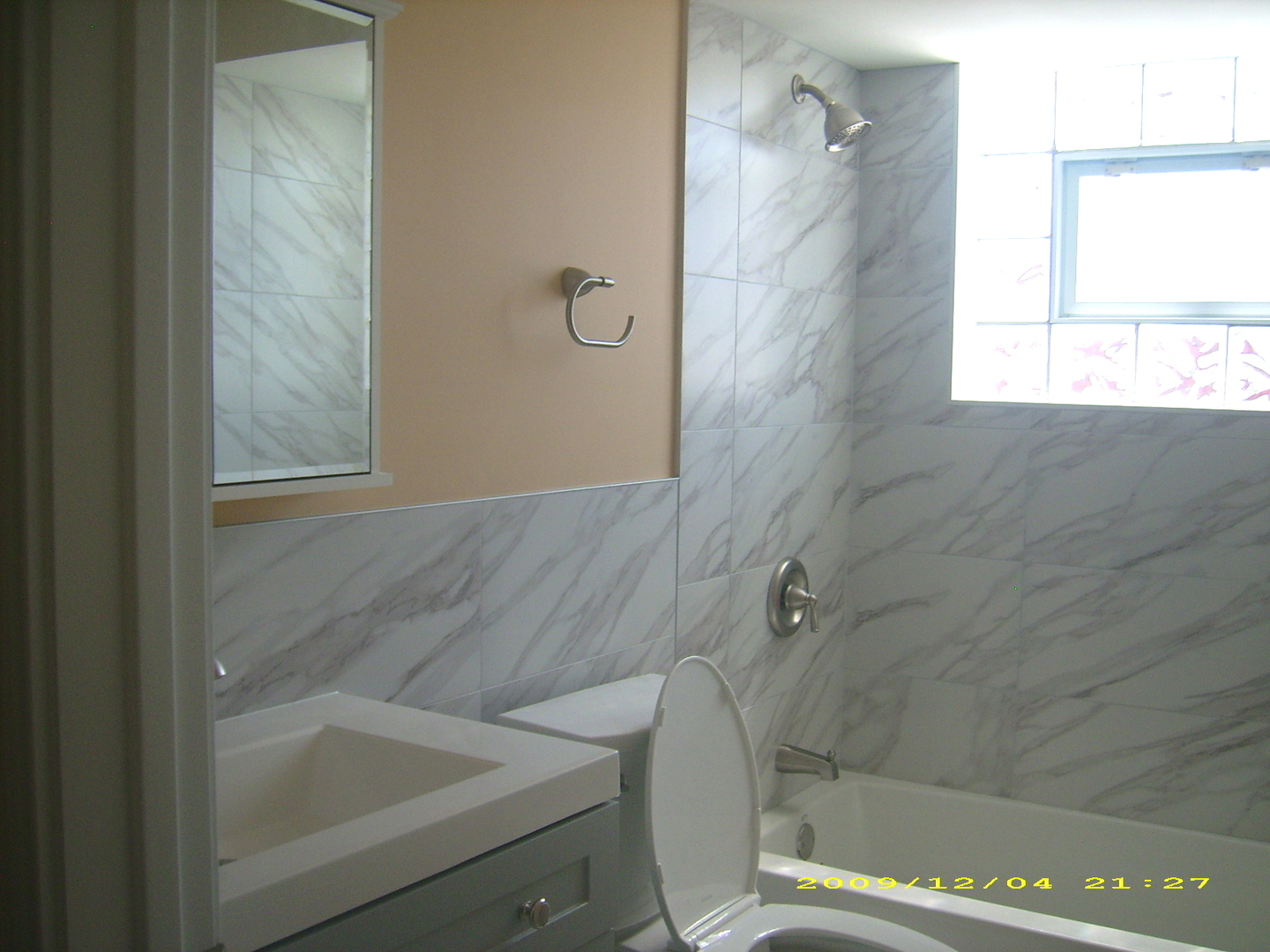 7019 West Irving Park Road, Unit 2 Chicago, IL 60634 - Photo 8 of 14 a bathroom with a bathtub and window