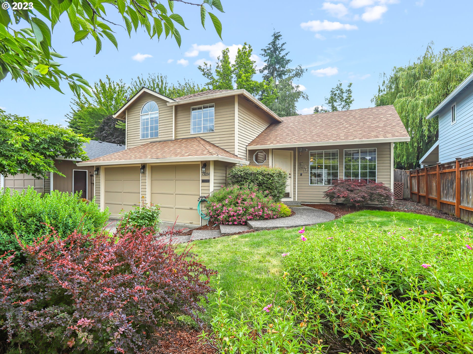 a front view of a house with garden