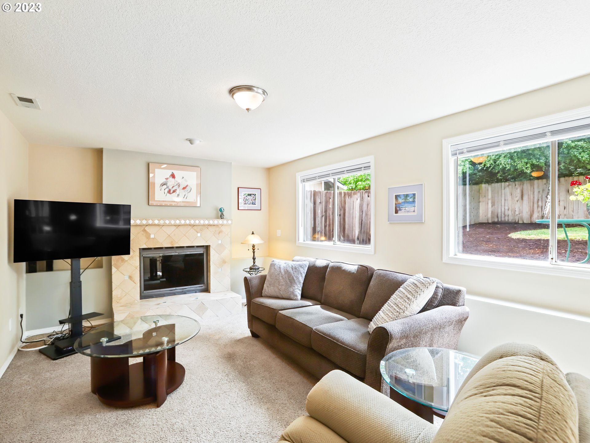 13224 Southwest Shore Drive Portland, OR 97223 - Photo 14 of 30 a living room with furniture a flat screen tv and a fireplace