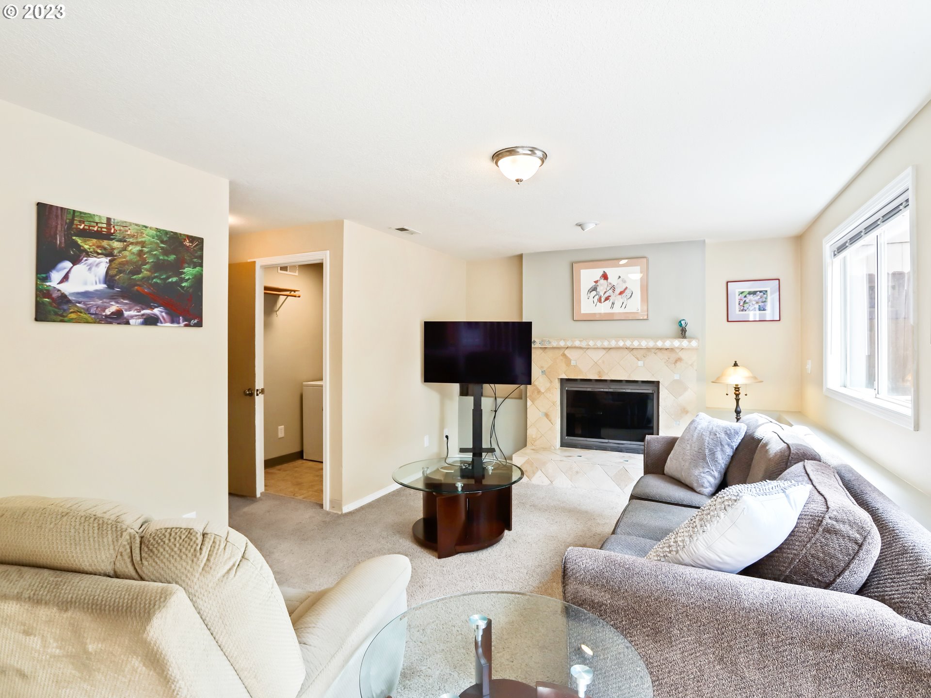 13224 Southwest Shore Drive Portland, OR 97223 - Photo 15 of 30 a living room with furniture a fireplace and a flat screen tv