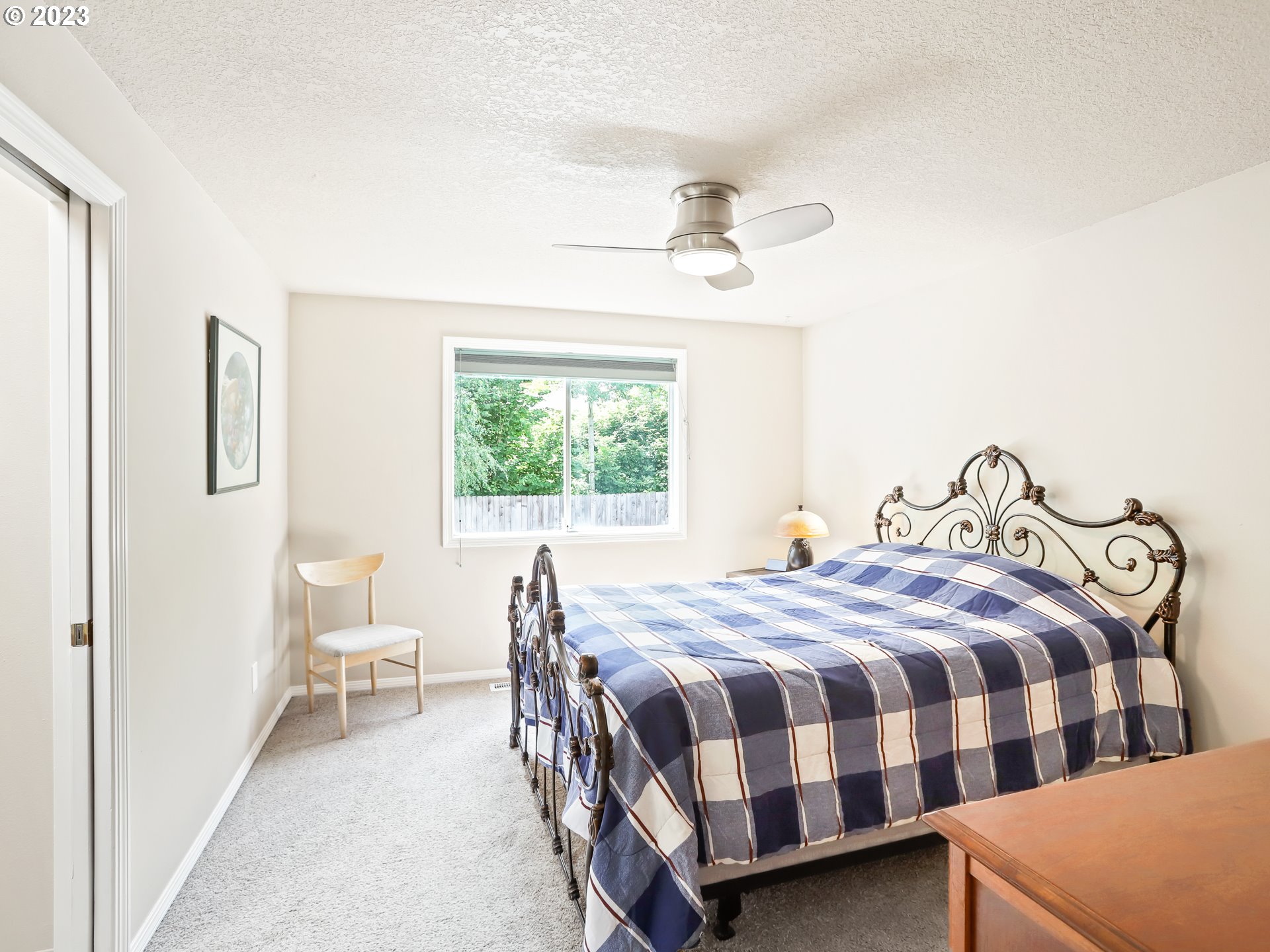 13224 Southwest Shore Drive Portland, OR 97223 - Photo 17 of 30 a bedroom with a bed a table and chair