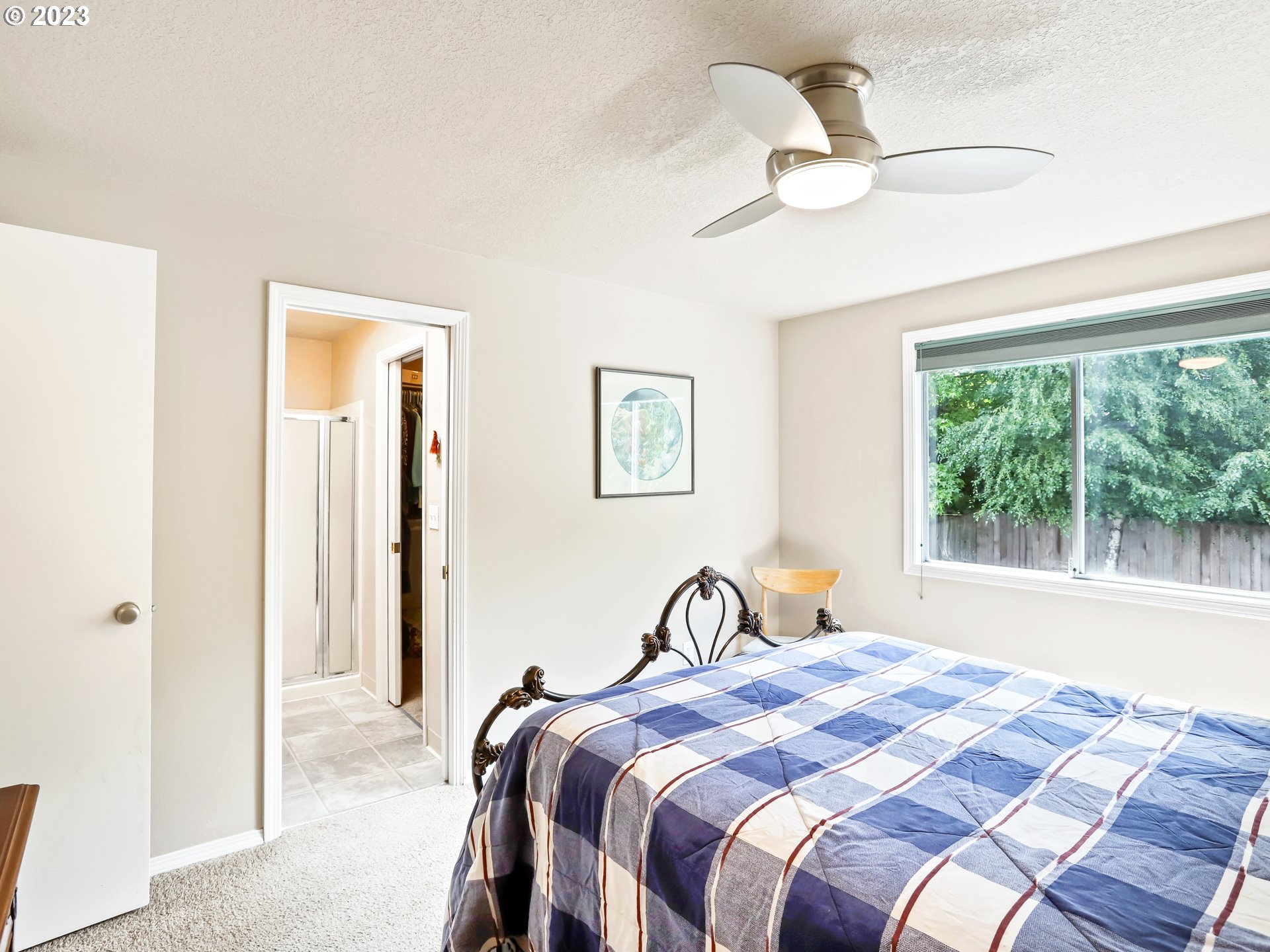 13224 Southwest Shore Drive Portland, OR 97223 - Photo 18 of 30 a bedroom with a bed and a window