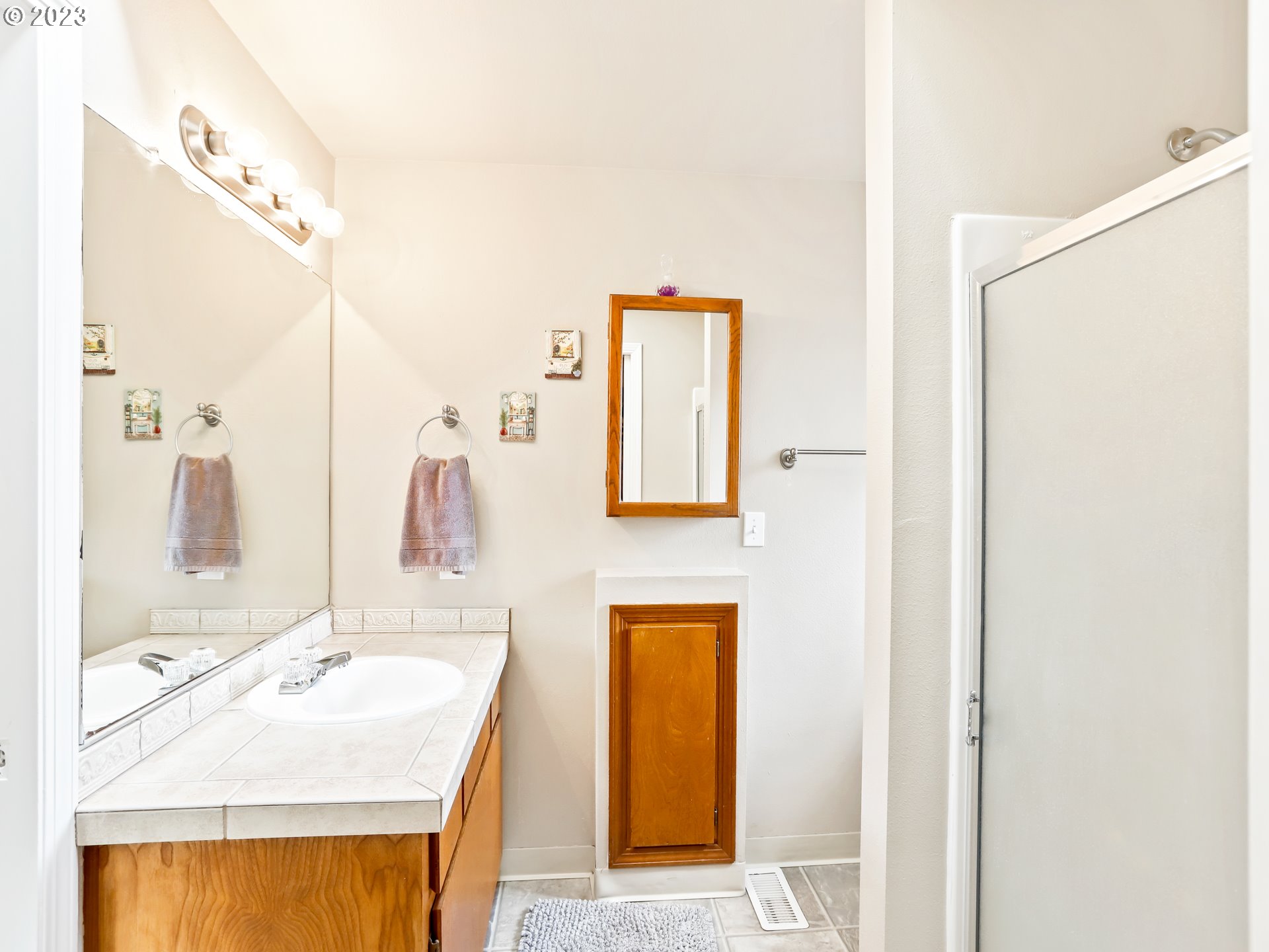 13224 Southwest Shore Drive Portland, OR 97223 - Photo 19 of 30 a bathroom with a sink and a mirror