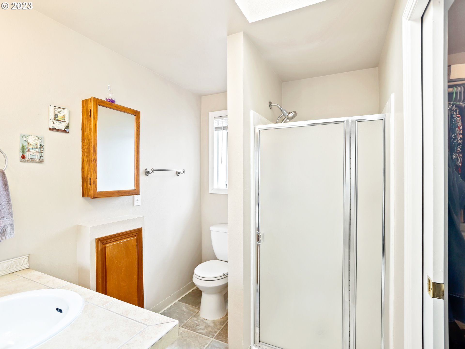 13224 Southwest Shore Drive Portland, OR 97223 - Photo 20 of 30 a bathroom with a toilet sink and a mirror