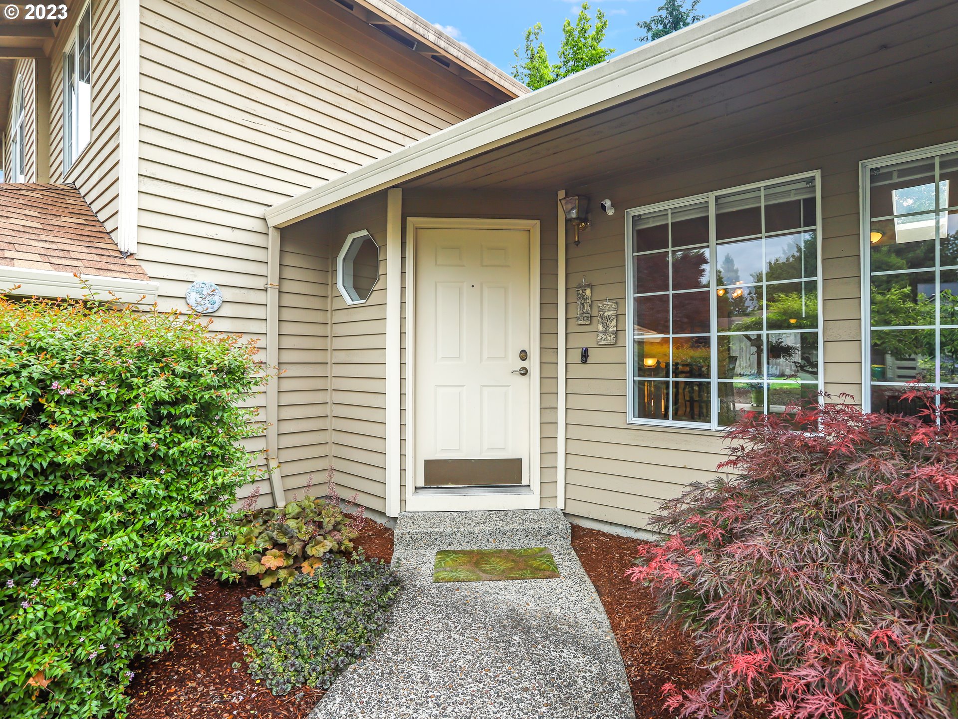 13224 Southwest Shore Drive Portland, OR 97223 - Photo 2 of 30 a front view of a house with a garden