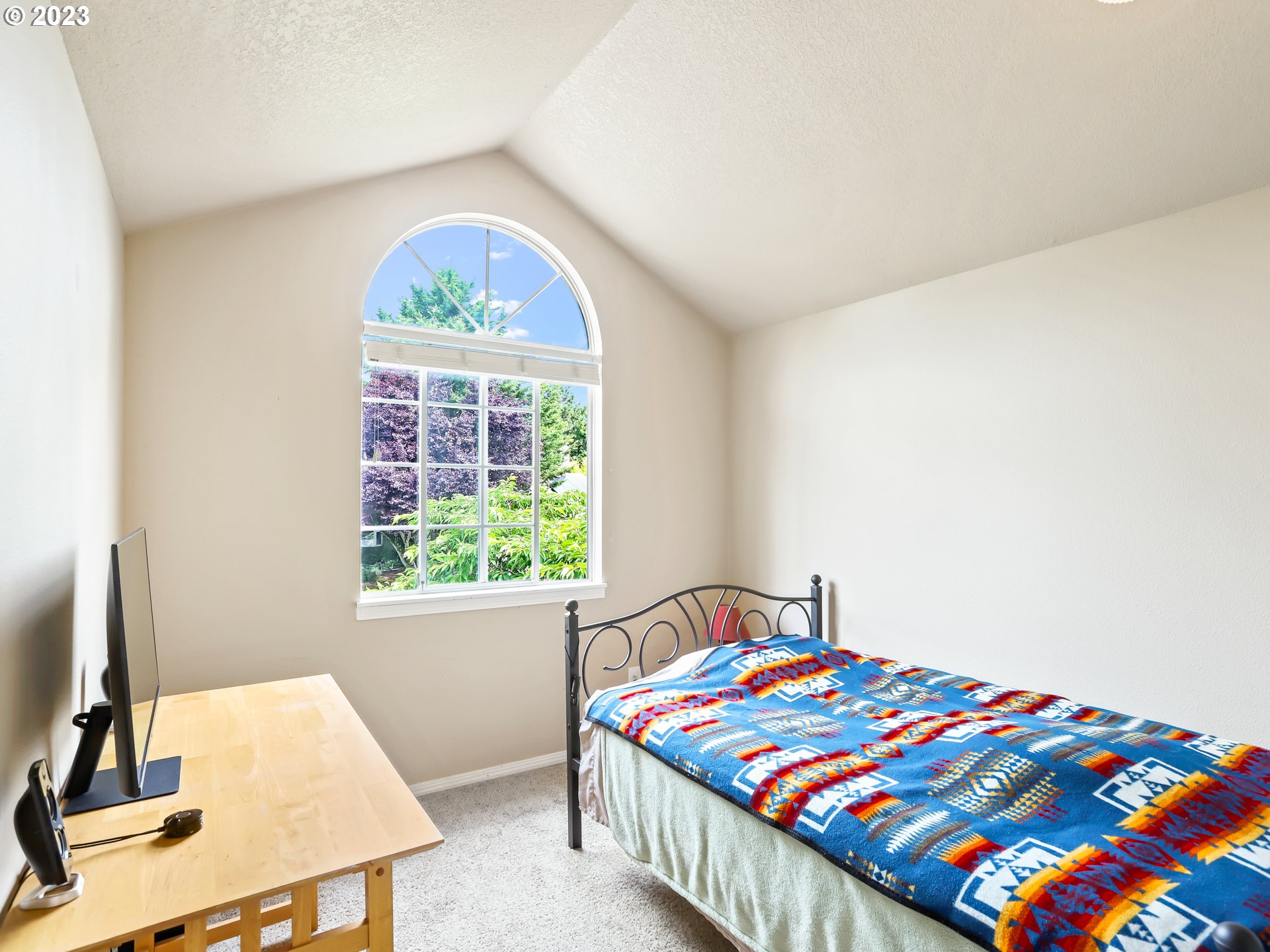 13224 Southwest Shore Drive Portland, OR 97223 - Photo 22 of 30 a bedroom with a bed and a window