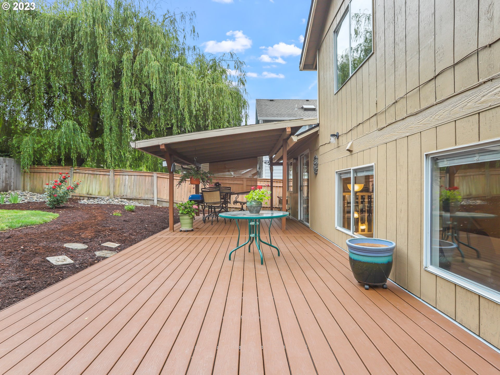 13224 Southwest Shore Drive Portland, OR 97223 - Photo 27 of 30 a view of a patio with table and chairs and wooden floor
