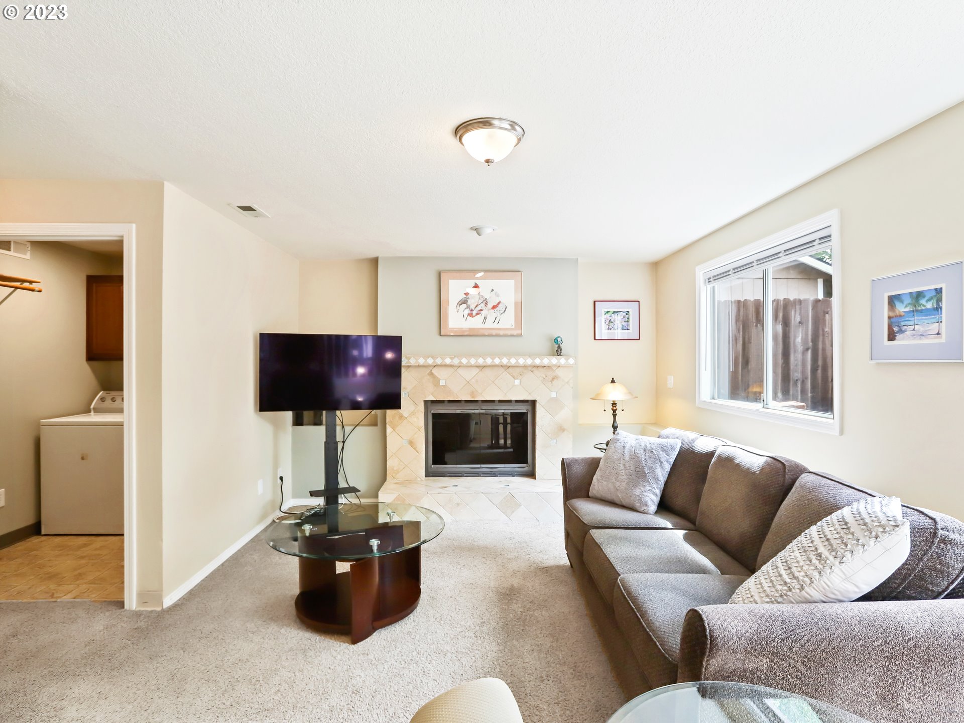 13224 Southwest Shore Drive Portland, OR 97223 - Photo 6 of 30 a living room with furniture a fireplace and a flat screen tv