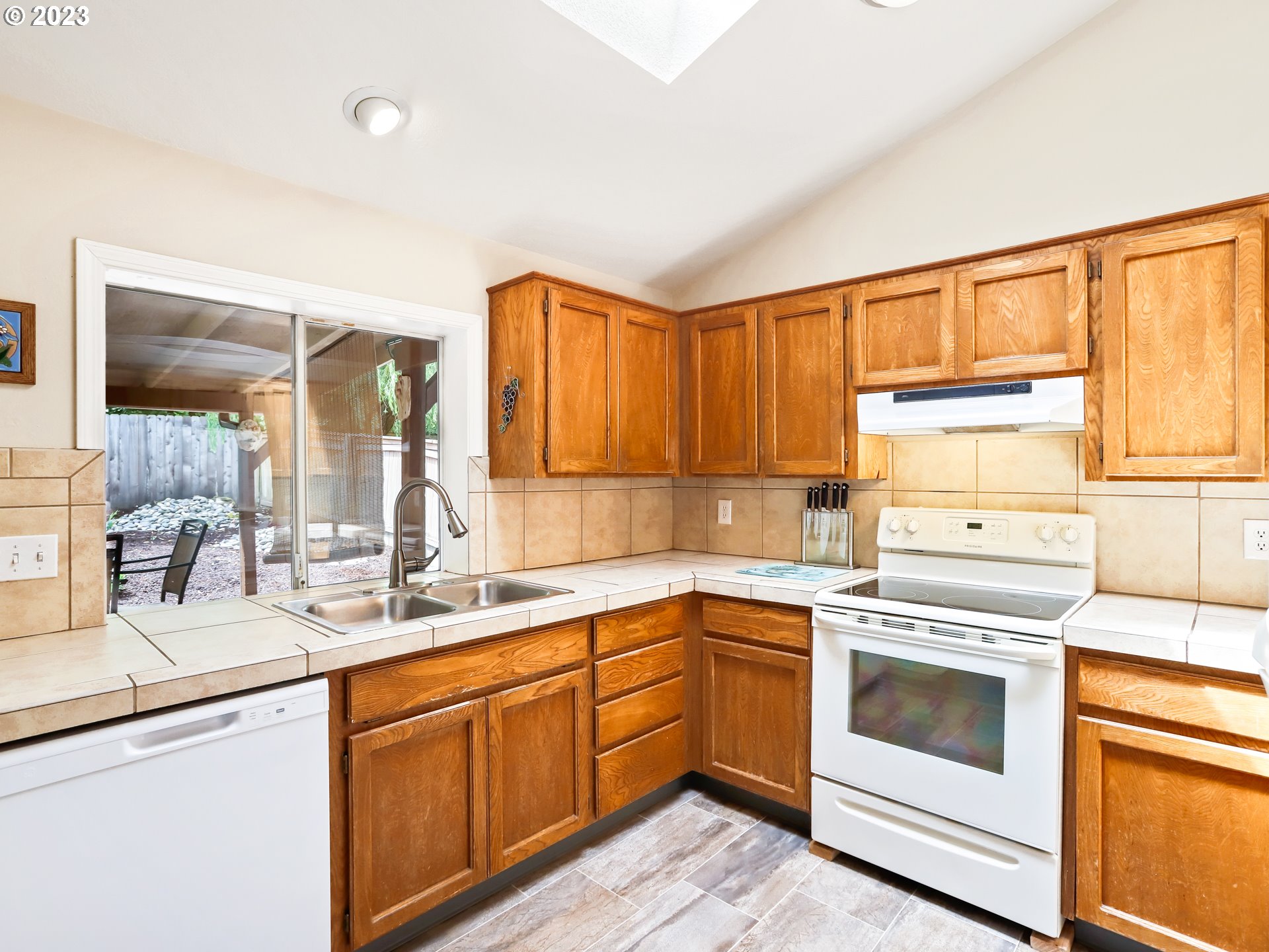13224 Southwest Shore Drive Portland, OR 97223 - Photo 10 of 30 a kitchen with a sink stove and cabinets