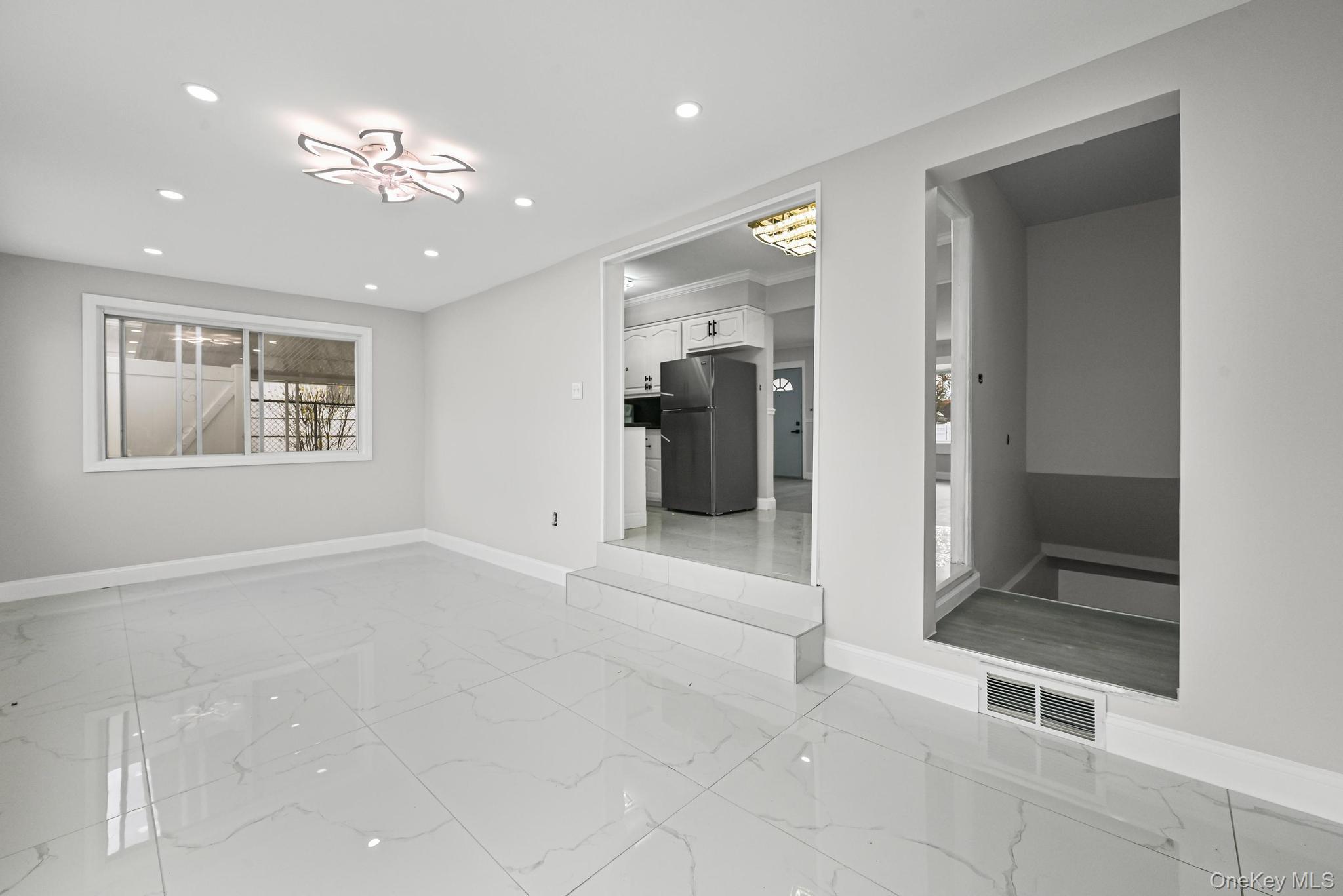 312 Coventry Road South West Hempstead, NY 11552 - Photo 16 of 30 Unfurnished room featuring light marble finish flooring and recessed lighting