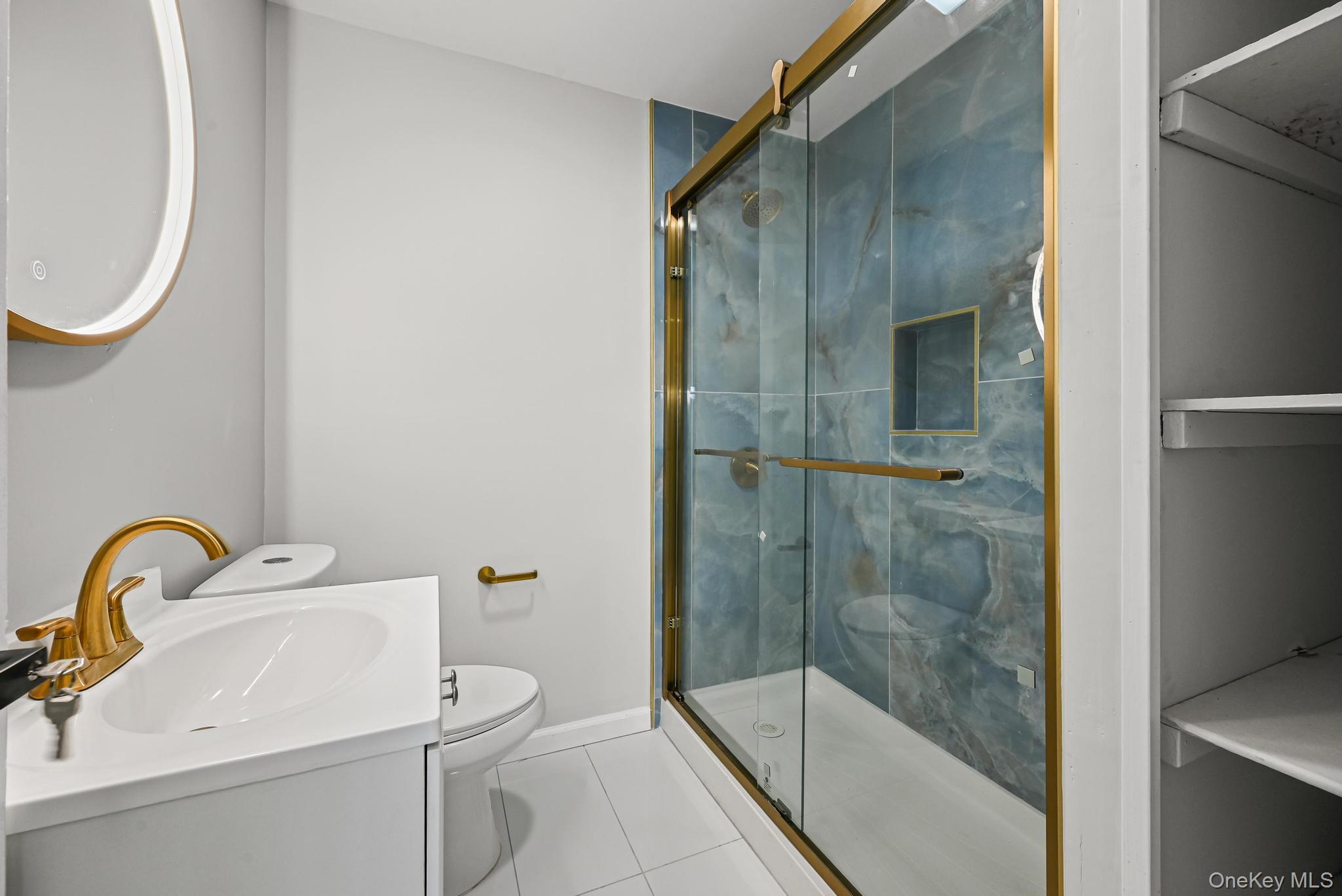 312 Coventry Road South West Hempstead, NY 11552 - Photo 20 of 30 Bathroom with tile patterned flooring, vanity, and a stall shower