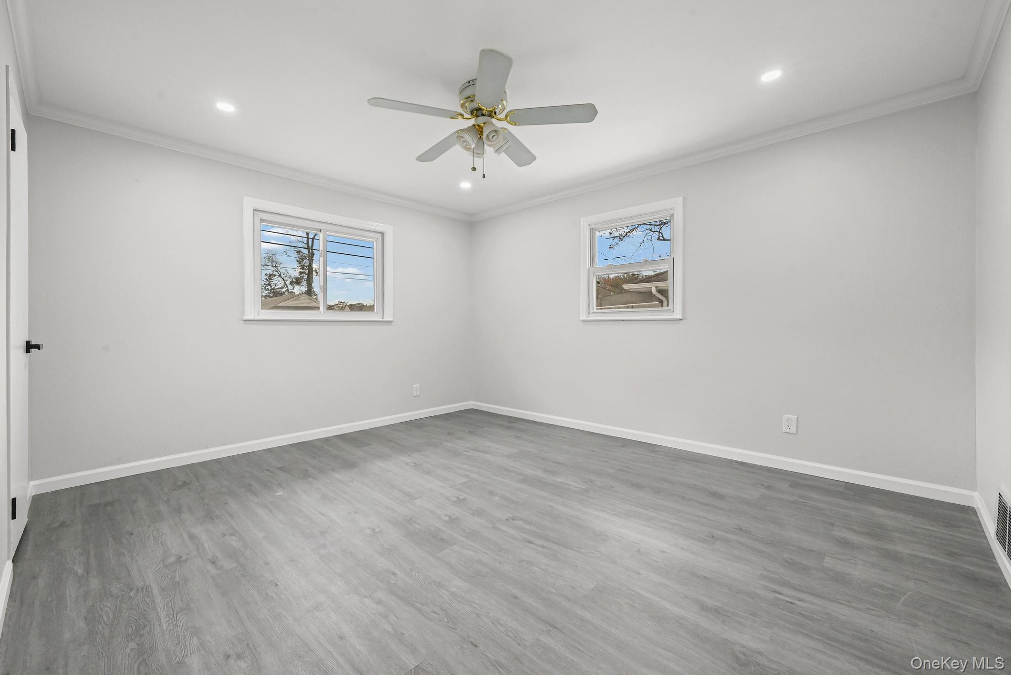 312 Coventry Road South West Hempstead, NY 11552 - Photo 25 of 30 Unfurnished room featuring crown molding, wood finished floors, plenty of natural light, ceiling fan, and recessed lighting