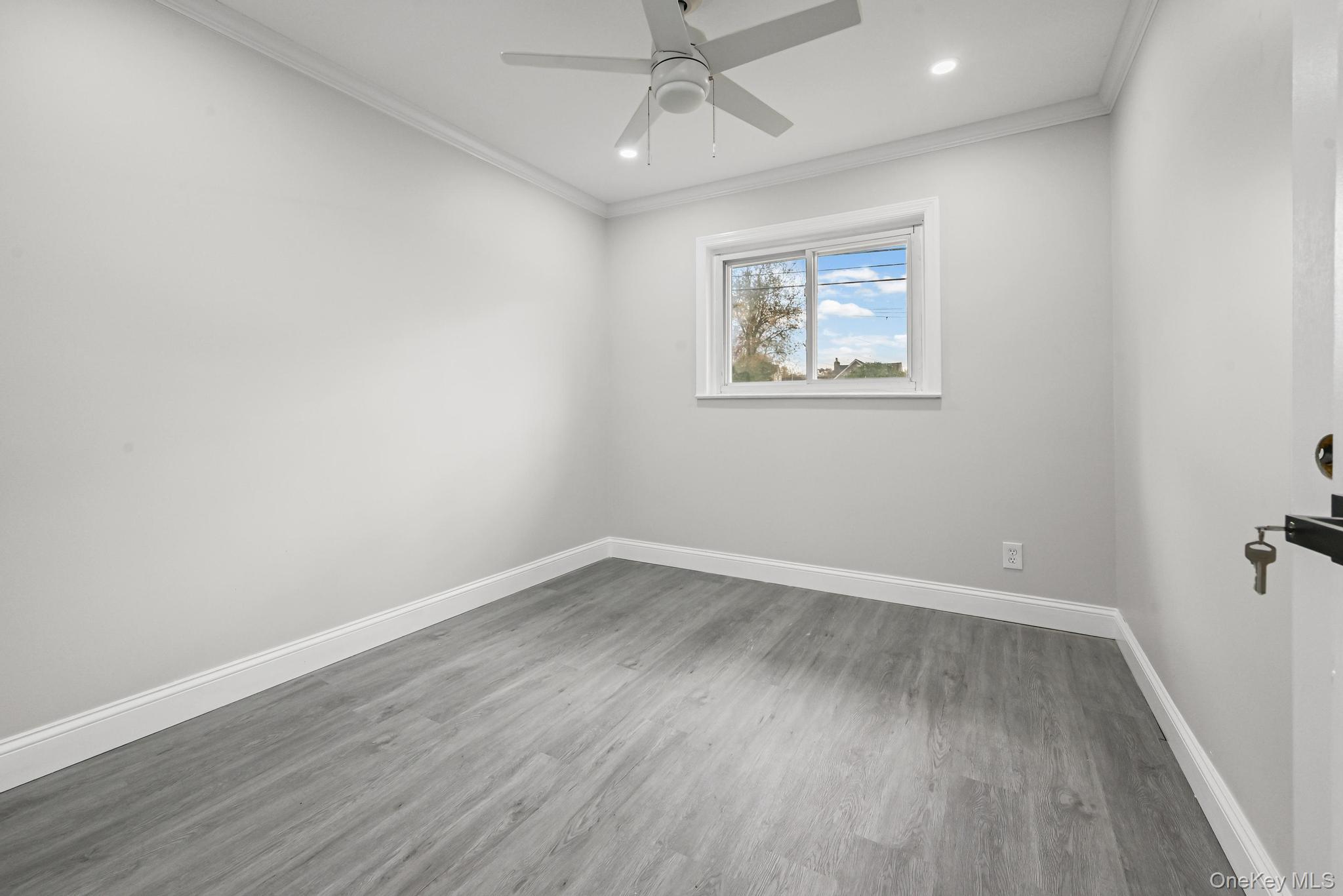 312 Coventry Road South West Hempstead, NY 11552 - Photo 26 of 30 Spare room with ornamental molding, wood finished floors, ceiling fan, and recessed lighting
