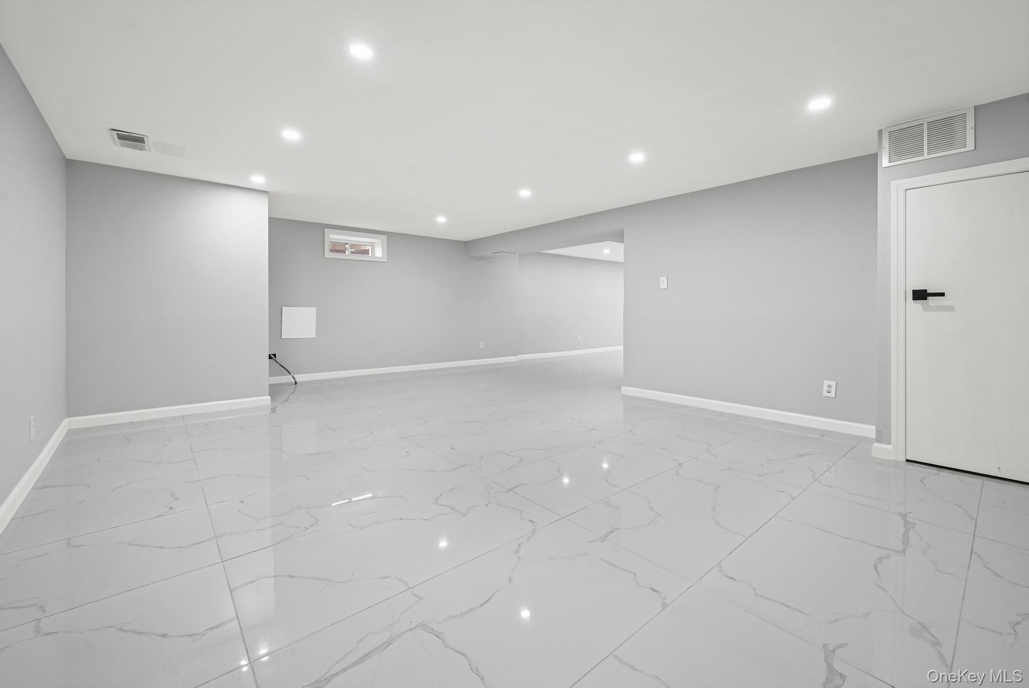 312 Coventry Road South West Hempstead, NY 11552 - Photo 29 of 30 Finished below grade area with recessed lighting and light marble finish flooring