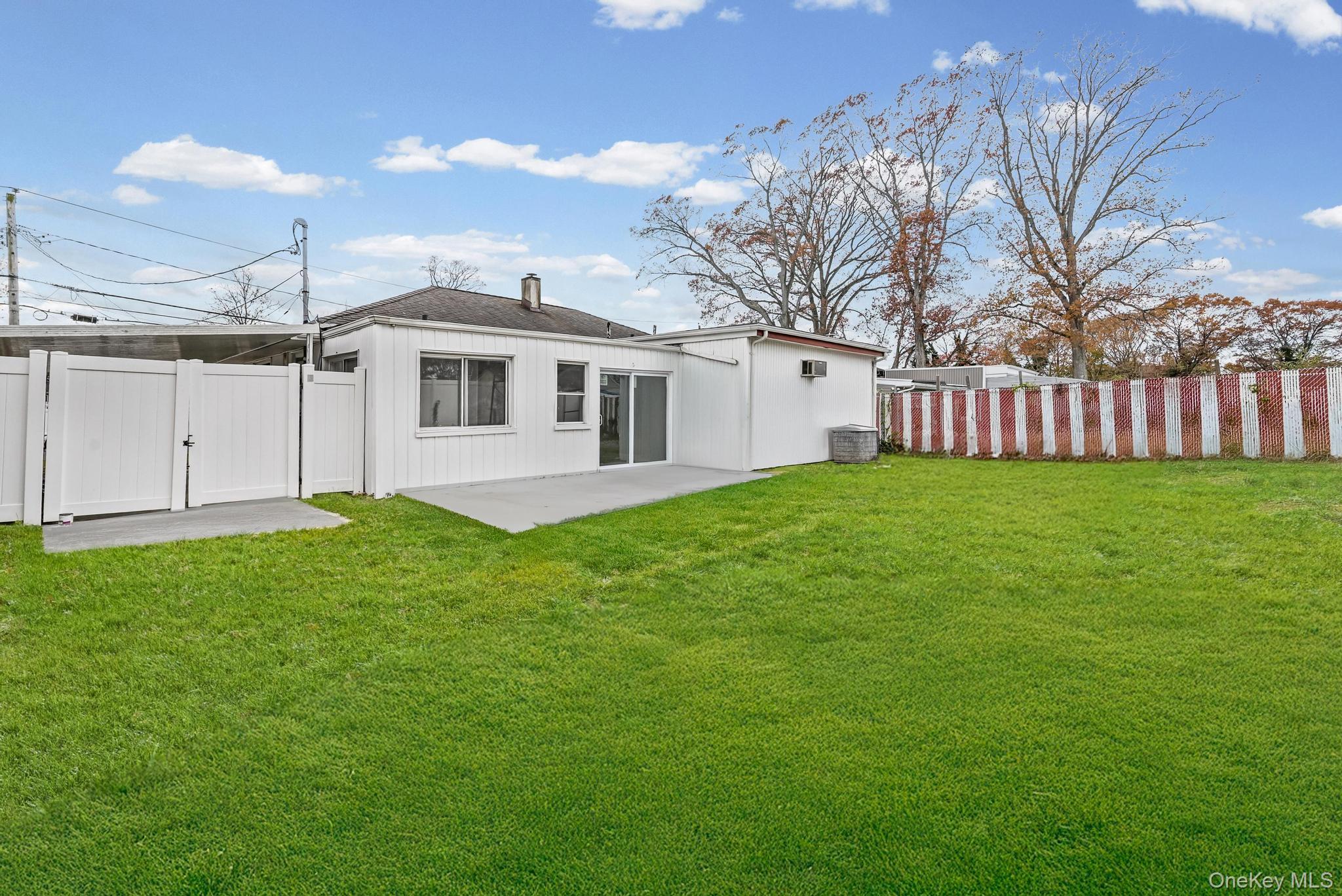 312 Coventry Road South West Hempstead, NY 11552 - Photo 5 of 30 Rear view of property with a gate, a fenced backyard, and a patio