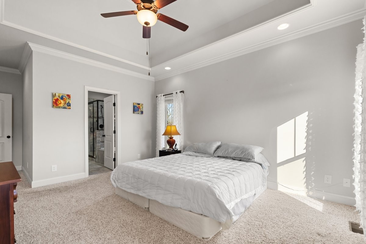 70 Cherokee Dock Road Lebanon, TN 37087 - Photo 23 of 48 a bedroom with a bed and a chandelier