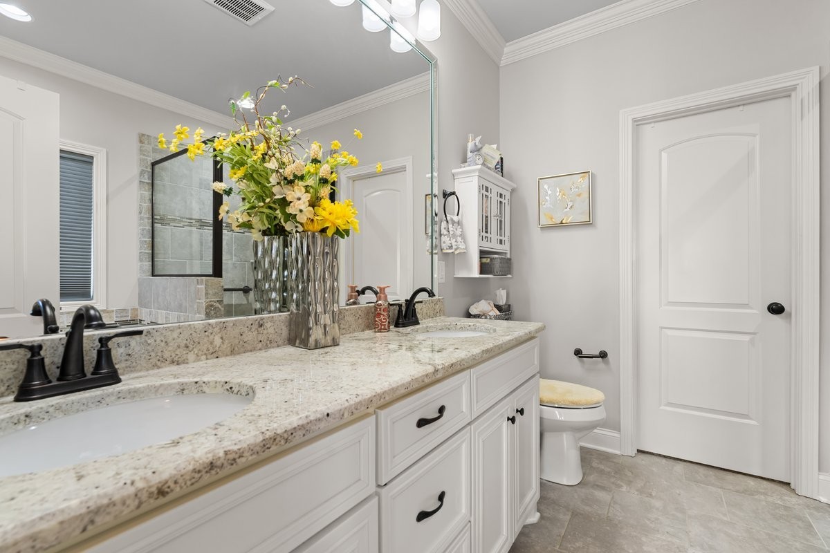 70 Cherokee Dock Road Lebanon, TN 37087 - Photo 24 of 48 a bathroom with a granite countertop sink a large mirror and a toilet