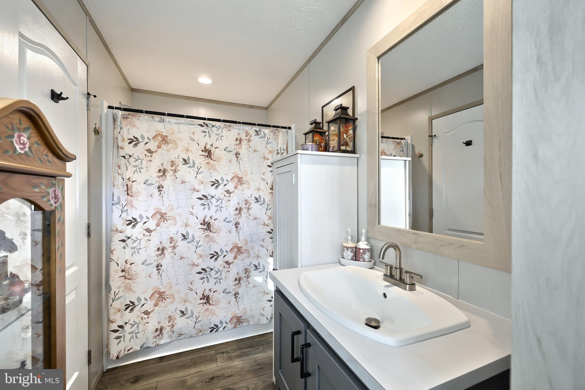 4 3rd Street York, PA 17406 - Photo 16 of 26 a bathroom with a sink a mirror a shower and vanity