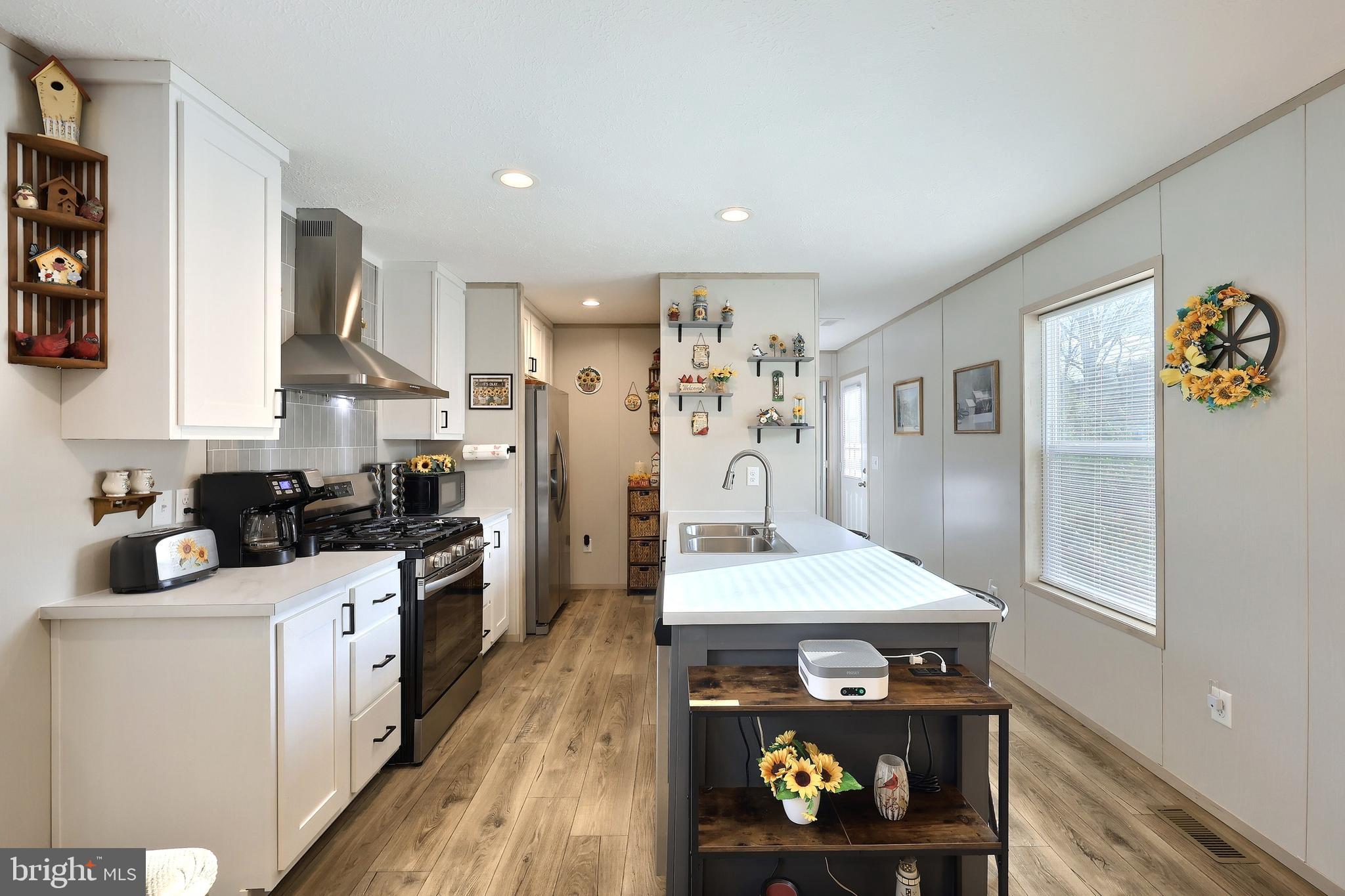 4 3rd Street York, PA 17406 - Photo 7 of 26 a kitchen with stainless steel appliances a stove a refrigerator a sink dishwasher and cabinets with wooden floor