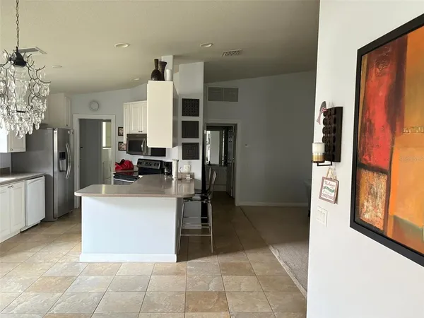 a kitchen with stainless steel appliances kitchen island granite countertop a refrigerator and a stove