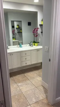 a bathroom with a sink vanity and mirror