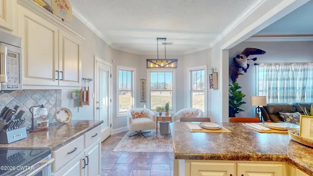 a living room with granite countertop furniture and floor to ceiling windows