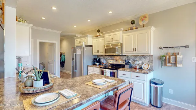 a kitchen that has a table and chairs in it