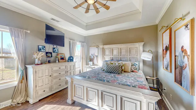 a bedroom with a large bed and a dresser