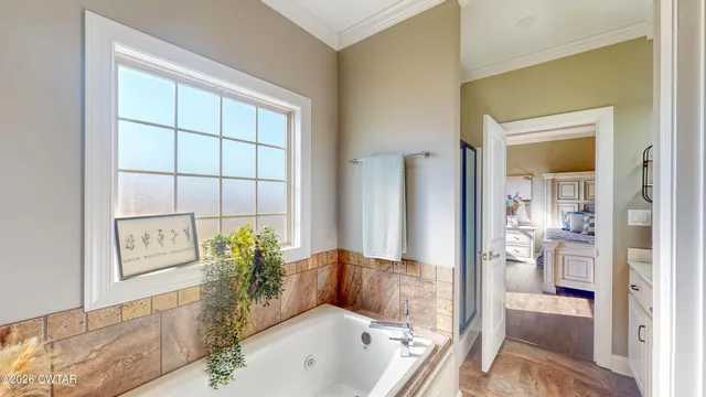 a bath room with a tub and shower