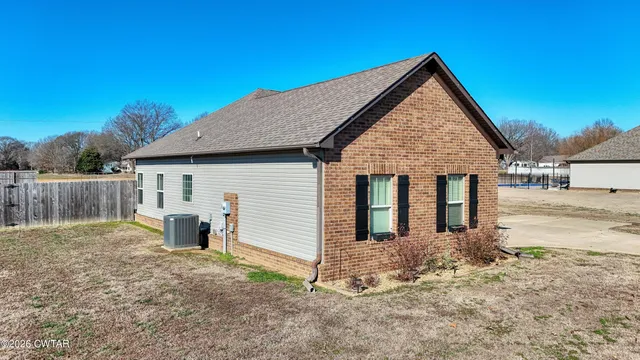 a view of house with backyard and trees