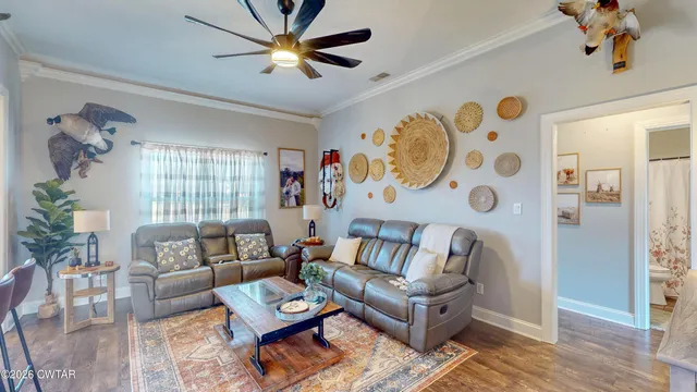 a living room with furniture and wooden floor