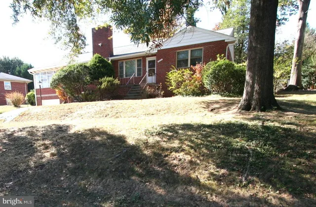 a view of a house with a tree in the background