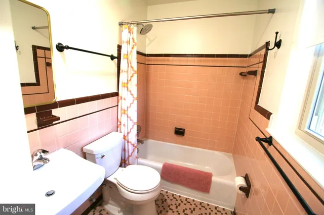 a bathroom with a toilet a sink and a shower