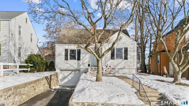 a view of a house with a yard covered in snow