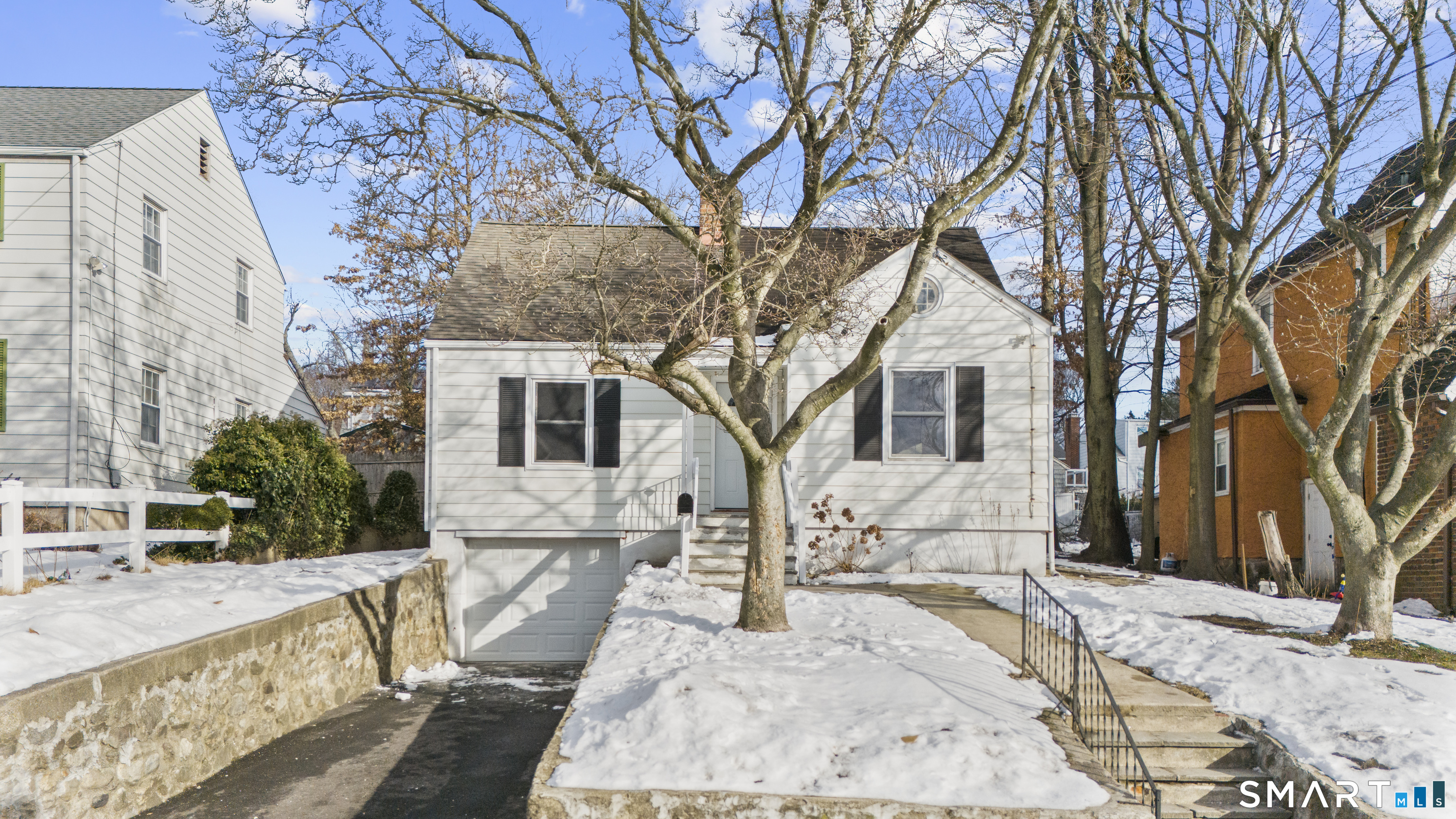 a view of a house with a yard covered in snow
